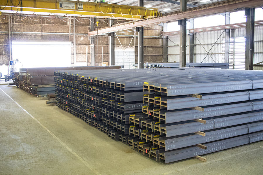 Bulk aggregate and structural steel materials prepared for construction projects